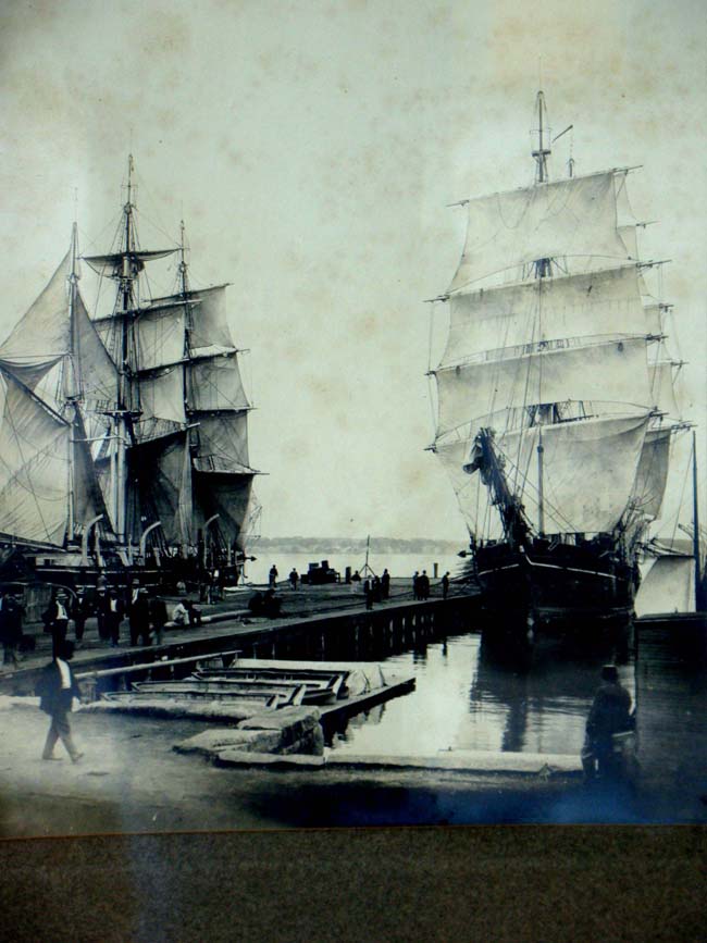 A fine original 19th century photo of two fully rigged whale ships drying their sails at a wharf in New Bedord